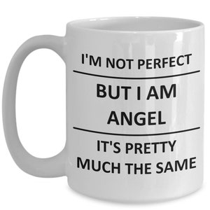 May include: White ceramic coffee mug with black text that reads "I'm not perfect but I am angel it's pretty much the same".
