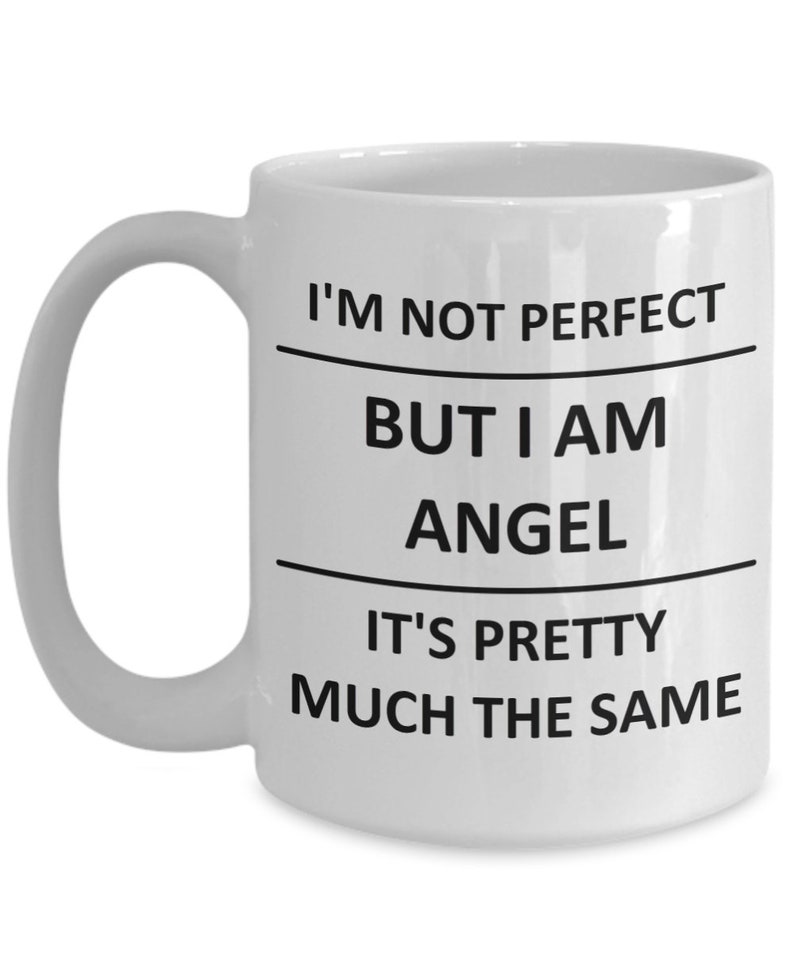 May include: White ceramic coffee mug with black text that reads "I'm not perfect but I am angel it's pretty much the same".