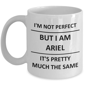 May include: White ceramic coffee mug with black text that reads "I'm not perfect but I am Ariel it's pretty much the same."
