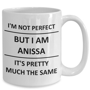 May include: White ceramic coffee mug with black text that reads "I'm not perfect but I am Anissa it's pretty much the same."