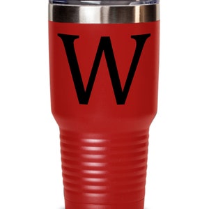 May include: A red stainless steel tumbler with a black letter W on the front. The tumbler has a double-wall insulated design and a lid.