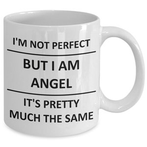 May include: White ceramic coffee mug with black text that reads "I'm not perfect but I am angel it's pretty much the same".