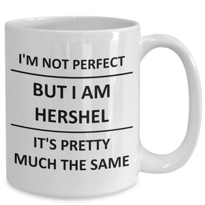 May include: White ceramic coffee mug with black text that reads "I'm not perfect but I am Hershel it's pretty much the same."