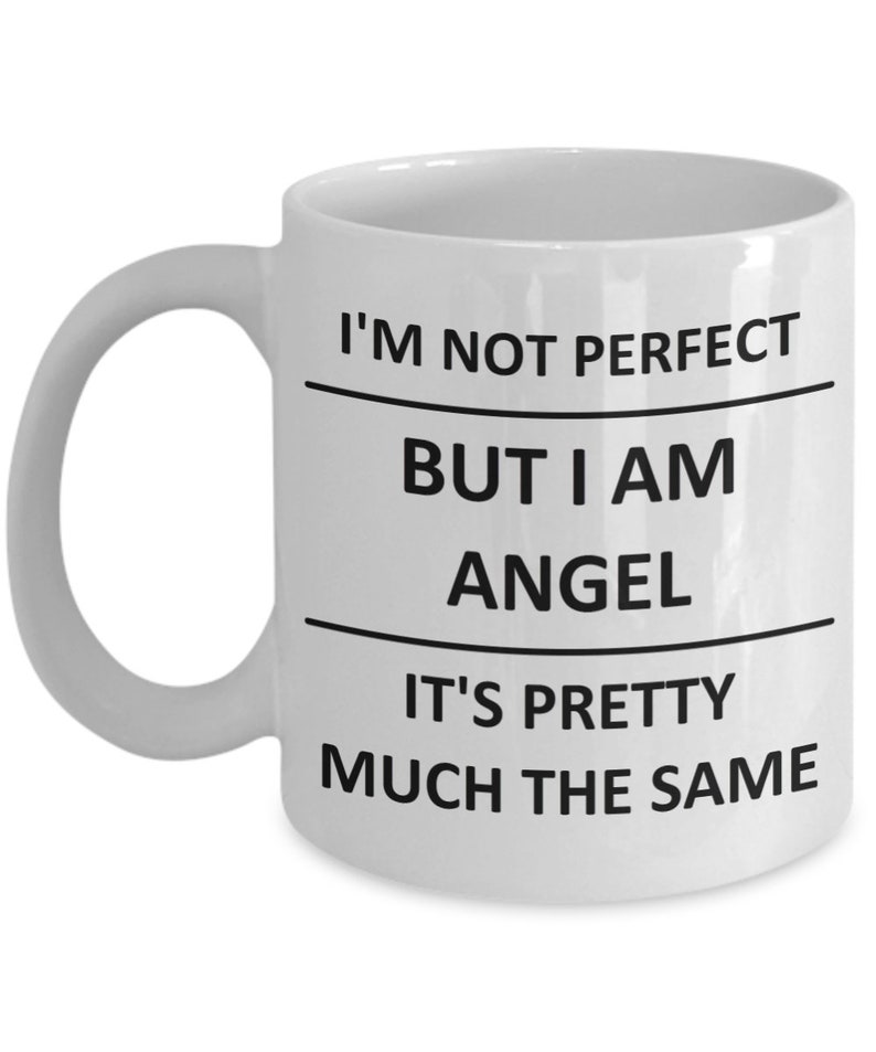May include: White ceramic coffee mug with black text that reads "I'm not perfect but I am angel it's pretty much the same".