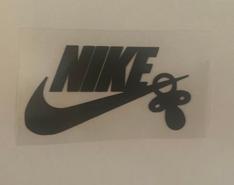 nike logo with pacifier