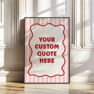 May include: A framed print with a black border. The print features a light pink and white striped background with a red wavy border around a cream-colored center. The text "YOUR CUSTOM QUOTE HERE" is in red.