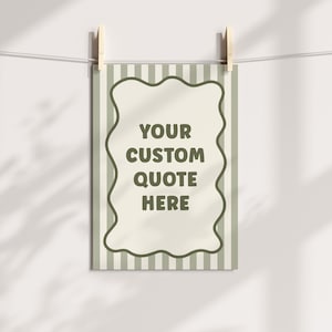 May include: A rectangular print with a wavy border and striped background is suspended by wooden clothespins. The print features the text "YOUR CUSTOM QUOTE HERE" in a dark green color, perfect for personalized decor.