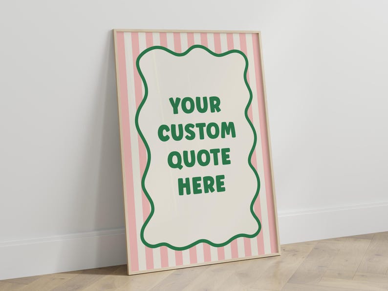 May include: A framed poster with a light wood frame. The background has pink and white vertical stripes. A cream-colored shape with a green border in the center contains the text "YOUR CUSTOM QUOTE HERE" in green.