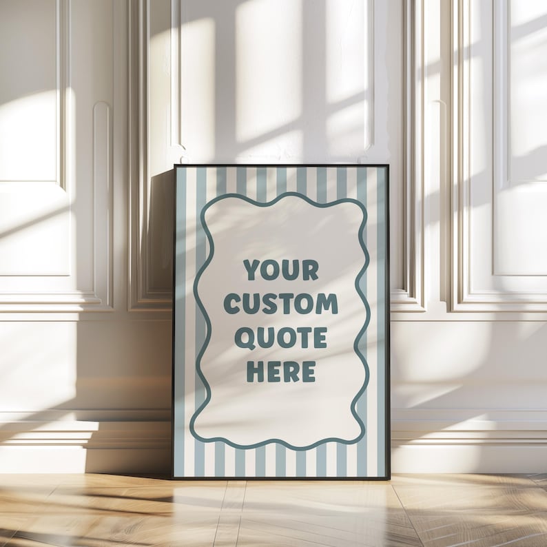 May include: A framed poster with a black border, featuring a light blue and white striped background. The poster has a white, wavy-edged shape in the center with the text "YOUR CUSTOM QUOTE HERE" in teal.