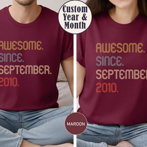 May include: A maroon t-shirt featuring the text "AWESOME. SINCE. SEPTEMBER. 2010." in a multi-colored, retro-style font. The shirt has a crew neckline and short sleeves. A circular graphic overlay at the top reads "Custom Year & Month".