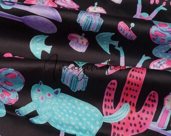 May include: Black fabric with a colorful print featuring a cat, a cactus, and various other whimsical designs. The print includes pink, blue, and green colors.