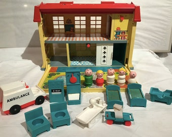 May include: A vintage Fisher-Price Little People playset featuring a two-story hospital building with an ambulance, beds, chairs, and medical equipment. The set includes five Little People figures, including a doctor, nurse, and patients.