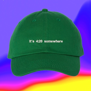 May include: A green baseball cap with the text "it's 4:20 somewhere" embroidered in white.