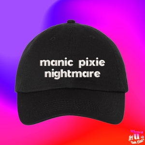 May include: Black baseball cap with white embroidered text that reads "manic pixie nightmare".