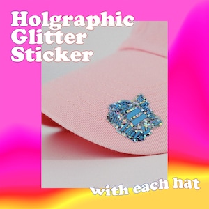 a picture of a pink hat with a blue brooch