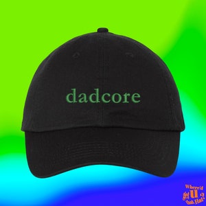 May include: A black baseball cap with the word "dadcore" embroidered in green on the front.