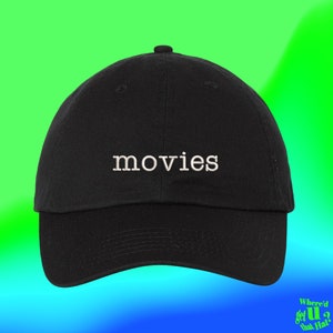 Peut inclure: Casquette de baseball noire avec un texte brodé en blanc qui dit "movies".