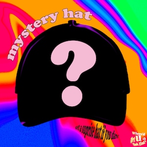 May include: Black baseball cap with a large pink question mark. The words "mystery hat" arc above the cap, and "get a surprise hat if you dare!" is written below. The background is a colorful swirl of orange, pink, and blue.
