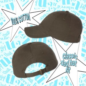 a gray baseball cap with text indicating its quality and style.