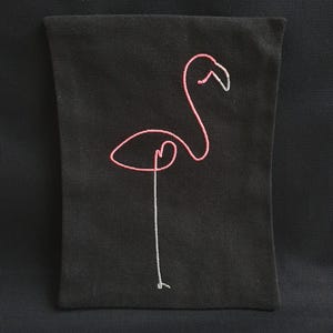 May include: Black rectangular pouch featuring a pink flamingo outline. The flamingo's body is pink, with a white beak and a single white leg. The design is embroidered on the black fabric, creating a minimalist and stylish aesthetic.