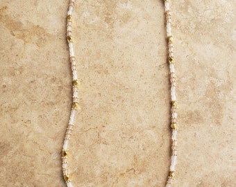 Fine necklace with light pink crystal glass beads and golden brass