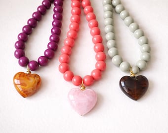 Necklace of opaque resin beads and marbled heart