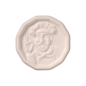 May include: White ceramic round plaque with a raised image of a chef wearing a hat and giving a thumbs up.