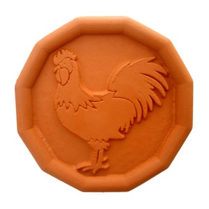 May include: A terracotta-colored, octagonal-shaped tile with a raised design of a rooster. The rooster is facing right and has a detailed comb, wattle, and feathers.