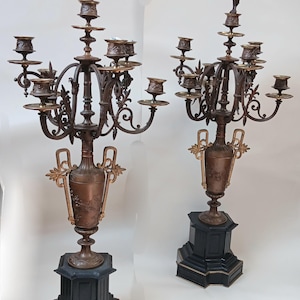 Pair of Mid 19th Century French ornate metal candelabra, each with five tiered candle holders on black stone base.  Circa 1850.