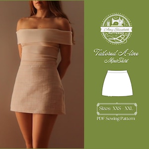 May include: A white A-line mini skirt sewing pattern with a model wearing a similar skirt. The pattern is available in sizes XXS to XXL. The pattern is a PDF download.