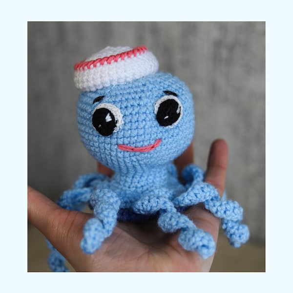 Crochet toy doll octopus with long tentacles, big eyes and small white hat, Baby's first soft handknitted ocean octopus toy