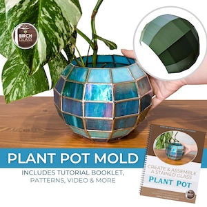 May include: A stained glass plant pot with a geometric design, featuring shades of blue and teal. The pot holds a green plant. The image includes a tutorial booklet and the text "Plant Pot Mold".