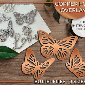 May include: Three copper foil butterfly cutouts in different sizes. The butterflies are on a wood background. The text "Butterflies - 3 Sizes" is at the bottom of the image. The text "Copper Foil Overlay" is at the top of the image.