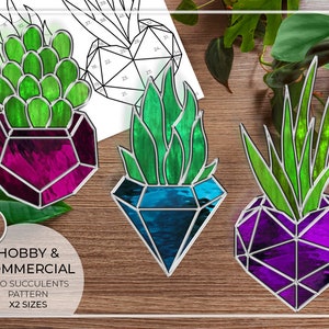 May include: Three stained glass succulent designs in geometric shapes. The succulents are in a heart, diamond, and a geometric shape. The designs are in shades of green, blue, and purple.