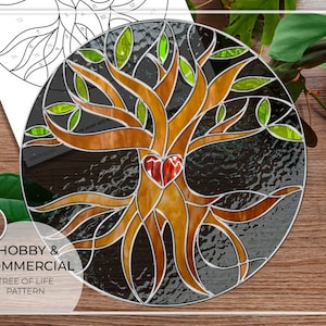 May include: A stained glass tree of life pattern with a red heart at the center. The tree has brown branches and green leaves. The pattern is on a black background. The text "Hobby & Commercial Tree of Life Pattern" is at the bottom of the image.