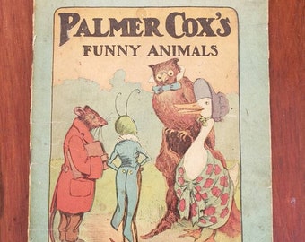 Op de afbeelding: Vintage kinderboek getiteld "Palmer Cox's Funny Animals". De omslag toont een kleurrijke illustratie van antropomorfe dieren, waaronder een muis, een insect, een uil en een gans. Het boek komt uit de Palmer Cox Series, nr. 160, en is gemaakt in de VS.
