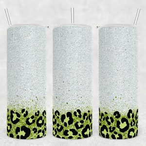 May include: Three stainless steel tumblers with a white glitter finish and a green and black leopard print design at the bottom.