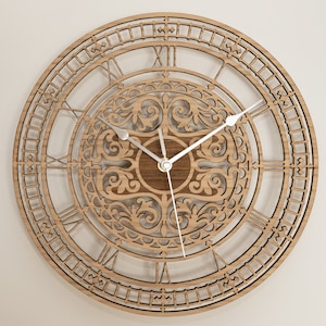 May include: A round wooden clock with a light brown finish. The clock face features Roman numerals and intricate cut-out designs. Silver-colored hands indicate the time. The clock's design includes a central circular pattern and an outer ring with a decorative border.