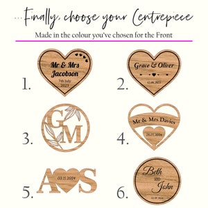 May include: Six different wooden centerpieces for a wedding or special event. The centerpieces are all heart-shaped or round and feature different designs and text. The designs include initials, names, and wedding dates. The text is in black and the wood is a light brown color.