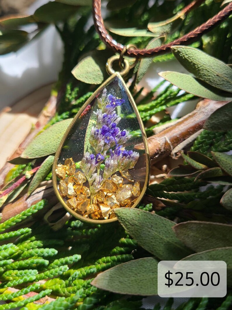 Purpleblue natural flower resin pendant with gold colored rock pieces