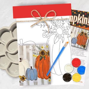 May include: A paint-by-number kit featuring a pumpkin and sunflower line art drawing, a finished color reference card, a blue-handled paintbrush, a light gray plastic paint palette, and four small circular paint pots in red, blue, yellow, and black.