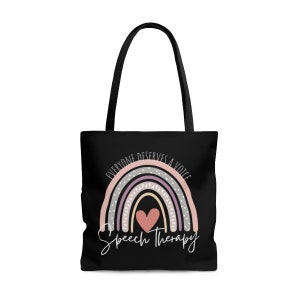 May include: Black tote bag with a rainbow design and the text "Everyone deserves a voice" and "Speech Therapy". The rainbow is in shades of pink, purple, and gray with a white heart in the center.