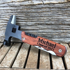 May include: A multi-tool with a hammer, wrench, and knife. The tool has a wooden handle with the name "Michael Class of 2021" engraved on it.