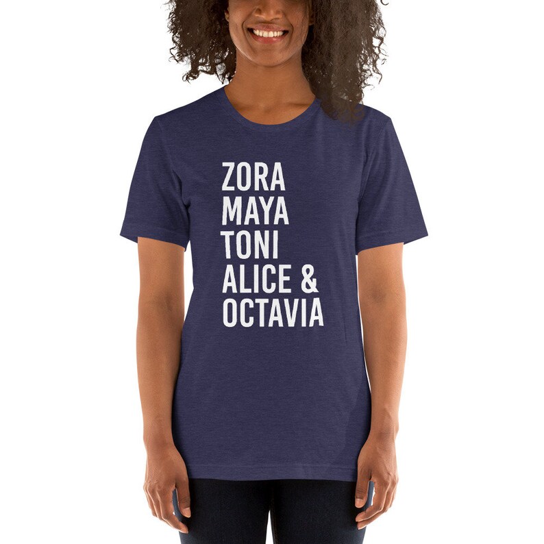 May include: A navy blue t-shirt with white text that reads "Zora Maya Toni Alice & Octavia".