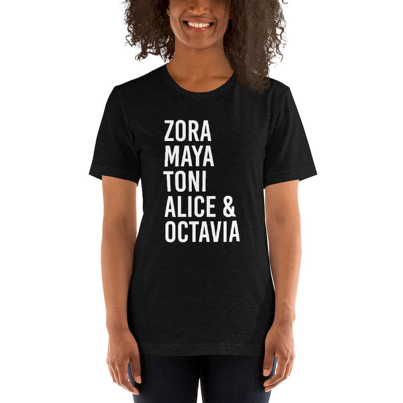 May include: A black t-shirt with white text that reads "Zora Maya Toni Alice & Octavia".