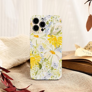 May include: A floral phone case featuring a watercolor design of yellow daisies, white flowers, and blue accents. The case has a glossy finish and a camera cutout for a smartphone.