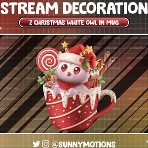 May include: A white owl wearing a Santa hat sits in a red and white mug with a candy cane, gingerbread, and other Christmas decorations. The text "2 CHRISTMAS WHITE OWL IN MUG" is above the mug.
