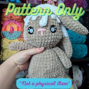 May include: A crochet pattern for a plush bunny toy. The bunny is brown with white fur on its head and has large black eyes. The pattern is available for purchase and is not a physical item. The text "Pattern Only" and "Not a physical Item" is visible in the image.