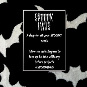 May include: Black and white image with a white bat silhouette on a black background. A white rectangle with black text reads "SPOOOK HAUS" and "A shop for all your SPOOOKY needs." Below the text is "Follow me on Instagram to keep up to date with any future projects." and "@SPOOOKHAUS".