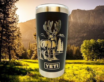 May include: Black Yeti tumbler with a gold-colored deer silhouette design and the word "YETI" printed on the bottom.